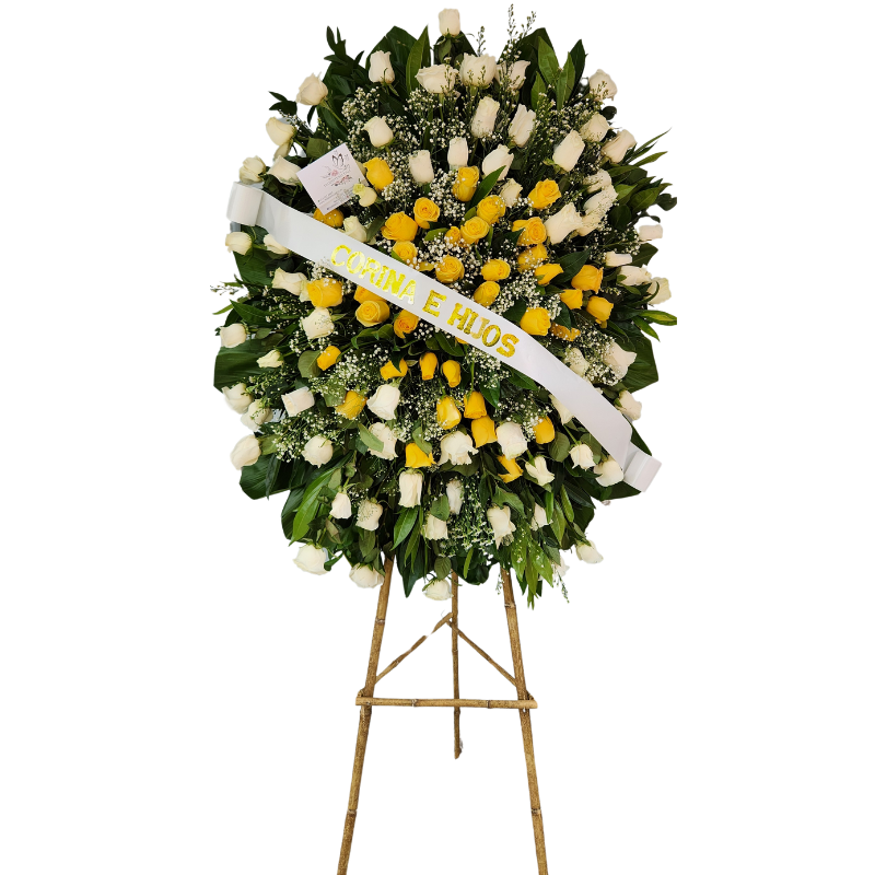 Corona fúnebre con rosas blancas, rosas amarillas, follaje verde y detalles en perlas.