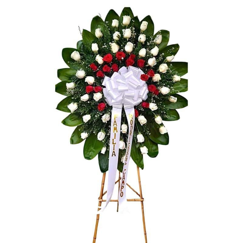 Corona fúnebre con rosas blancas, rojas y cinta personalizada