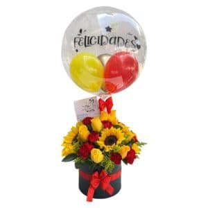 Cilindro Redondo con Rosas Amarillas, Girasoles, Claveles Rojos y Globo Personalizado